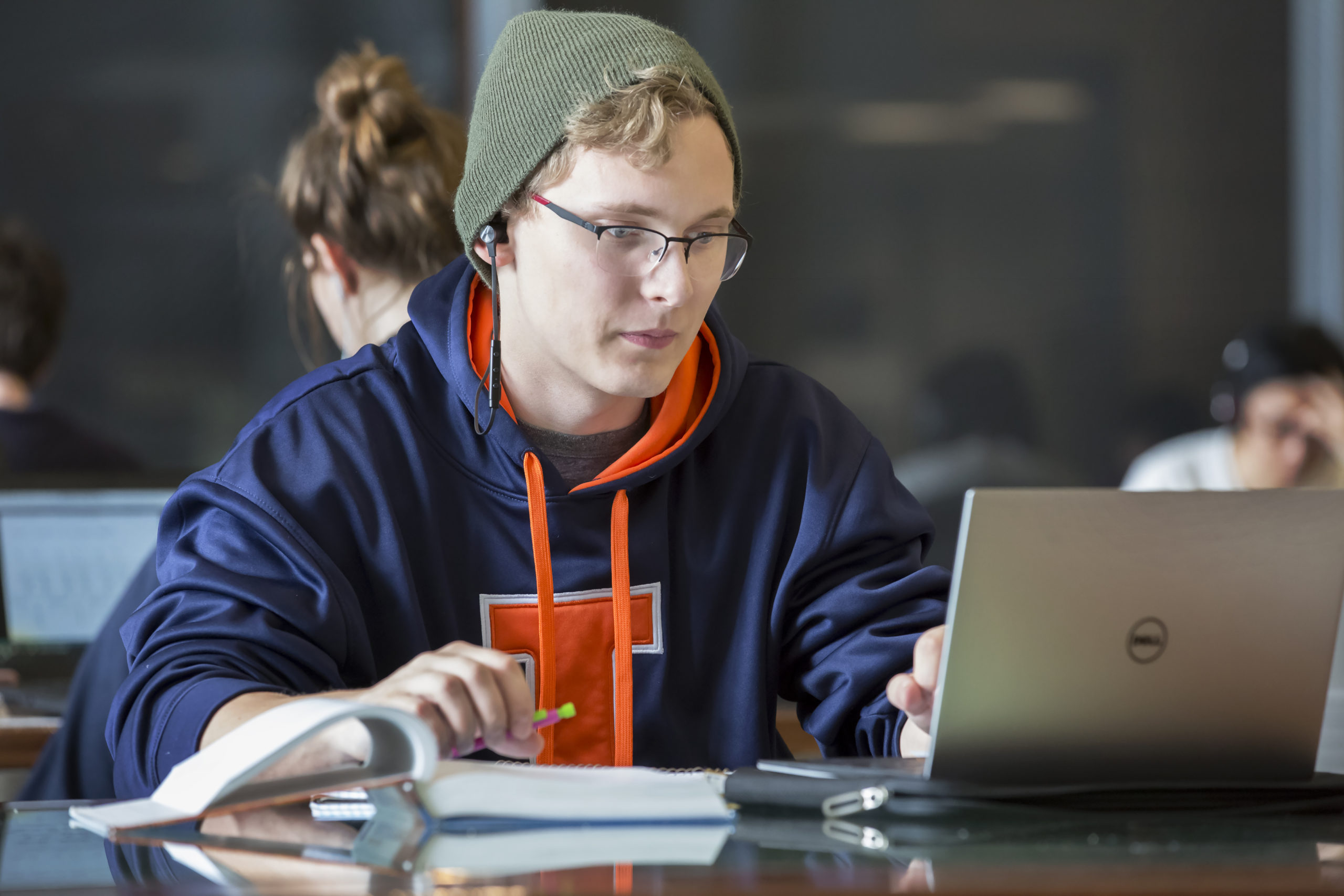 Photograph of a male student studying in front of a laptop in the Electrical and Computer Engineering building