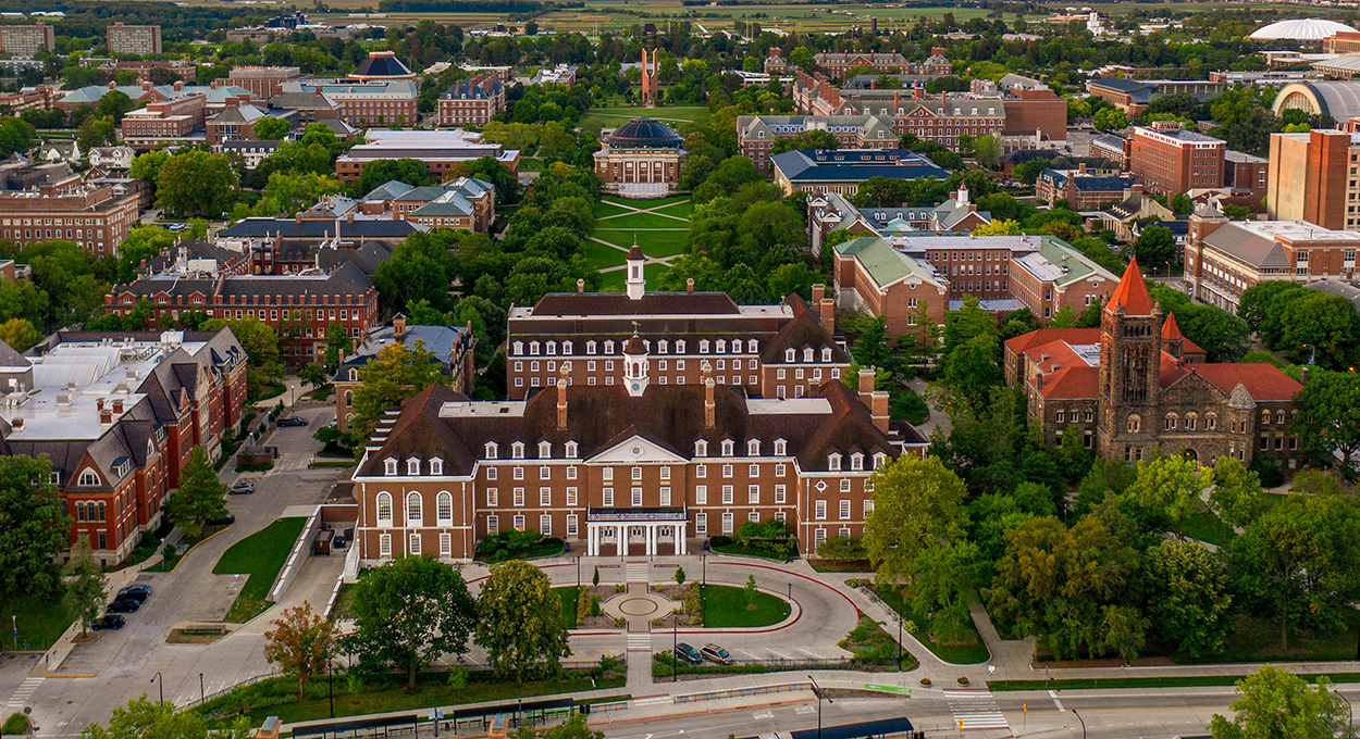 An overhead drone shot of the University of Illinois campus. The Illini Union is prominent in the foreground.