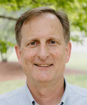 Greg Bauer smiling outside for a photo